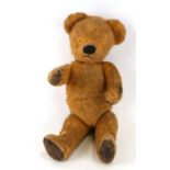 A vintage jointed plush teddy bear, 39cms high.