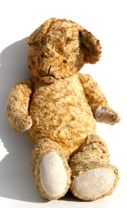 A vintage jointed plush teddy bear, 65cms high.