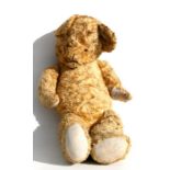 A vintage jointed plush teddy bear, 65cms high.