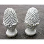 A pair of well weathered painted reconstituted stone pineapple finials, 60cms high (2).