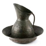 A large Islamic / Turkish tinned copper jug, 36cms high; together with a similar bowl, 43cms