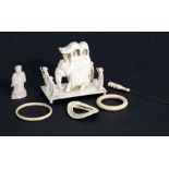 An early 20th century Indian ivory group depicting an elephant and attendants, 9cms wide; and