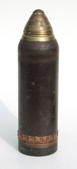 An inert WW1 artillery shell and fuze in two parts. The brass fuze date 1916. Having a diameter of