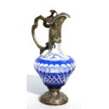 A Bohemian blue flashed glass claret jug with silver plated mounts, 31cms high.