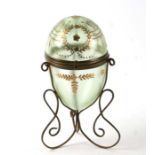 A late 19th century Palais Royale style egg shaped green glass box on gilt metal stand, 17cms high.