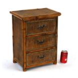A miniature bamboo chest with three drawers, 38cms wide.Condition ReportMissing the upright strip of