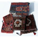 A Turkish or Bedouin camel bag; together with two similar smaller bags; a cushion and a pine box