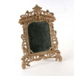 A painted gilt metal table mirror, overall 27 by 38cms.