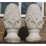 A pair of well weathered painted reconstituted stone pineapple finials, 60cms high (2).