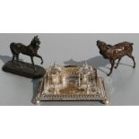 A silver plated twin inkwell desk stand, 21cms wide; together with a bronzed spelter figure of a