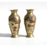 A pair of Japanese Meiji period mixed metal baluster vases, each decorated in relief with storks