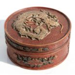 A Chinese cinnabar lacquer circular box and cover decorated with a dragon and prunus, 11cms