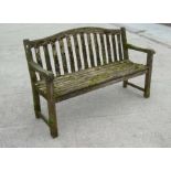 An Alexander Rose well weathered teak garden bench, 149cms wide.
