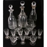 A mallet shaped glass decanter, 33cms high; together with two other decanters and stoppers and