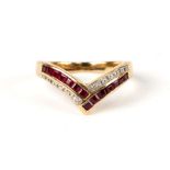 An 18ct gold wishbone ring with channel set rubies and diamonds, approx UK size 'J', 2.9g.