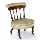 A late 19th century walnut nursing chair with upholstered seat.