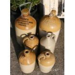 A collection of six stoneware flagons to include Trasks Ginger Beer, Yeovil, W. Goodridge Wines &