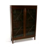 An Edwardian inlaid mahogany bookcase, the pair of astragal glazed doors enclosing a shelved