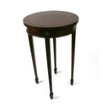 An Edwardian mahogany occasional table on carved tapering legs terminating in spade feet, 47cms