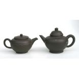 A Chinese Yixing pottery miniature teapot with impressed seal mark to the underside, 9cms high;