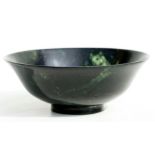 A figured jade / hardstone footed bowl, 13.5cms diameter.