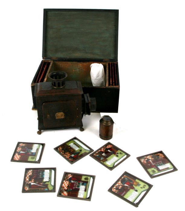 A late 19th century German tin table top Magic Lantern in original box; together with a box of magic