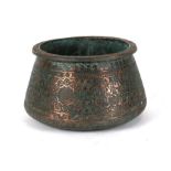 An Indo / Persian copper palm pot highly decorated with foliate scrolls, 16cms high.