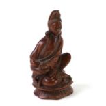 A Chinese hardwood figure depicting Guanyin, 9cms high.