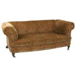 An Edwardian scroll arm upholstered sofa on turned front supports, 178cms wide.