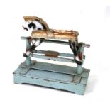 An early 20th century painted wooden rocking horse, 66cms long.