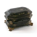 A Chinese lacquer two-division tea caddy decorated with gilded figures on a black ground with lion