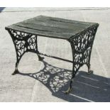 A garden table with pierced cast ends, 91cms wide.