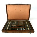 A opticians comprehensive cased lens test set in a padded oak case.