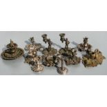 A group of bronze, brass and silver plated chamber or taper sticks, the largest 9cms high (11).