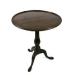 A George III mahogany occasional table on turned column and tripod base, 58cms diameter.