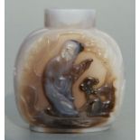 A Chinese figured agate snuff bottle decorated with figures, 6cms high.