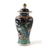 A Chinese famille noir baluster vase and cover decorated with birds and flowers, 26cms high.