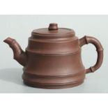 A Chinese Yixing pottery teapot with stylised bamboo spout and handle, impressed seal mark to the