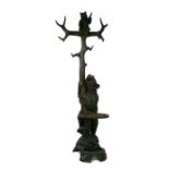 A 20th century Black Forest carved bear hallstand, the adult bear climbing the tree and looking up