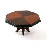 A specimen wood apprentice piece miniature table of octagonal form, 21cms wide.