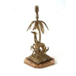 A brass table lamp depicting a giraffe under a palm tree mounted on an alabaster plinth, 41cms