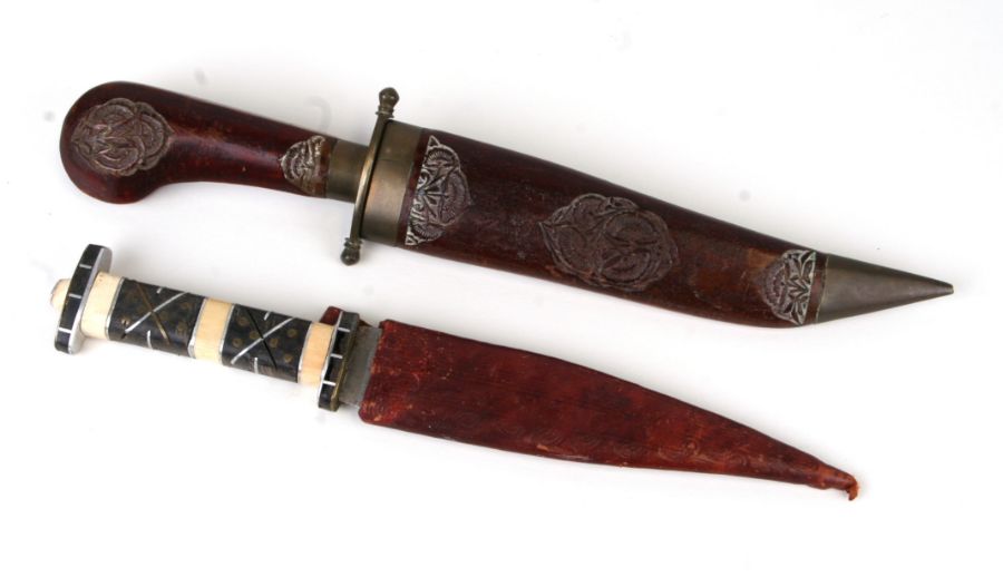 An Iznik style dagger with bone handle and leather sheath, 30cms long; together with another similar