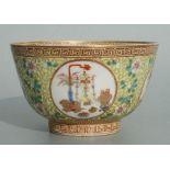 A Chinese famille rose bowl decorated with precious objects within roundels with foliate scrolls