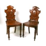 Two Victorian oak hall chairs.