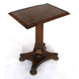 A William IV rosewood side table with moulded rectangular top on an octagonal tapering column and