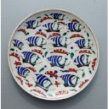 A Turkish / Iznik plate decorated with stylised sailing ships, 30cms diameter.