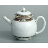 A Chinese famille rose teapot of globular form, decorated with sgraffito and flowers, 11cms high.