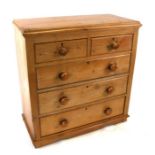 A Victorian stripped pine chest of two short and three graduated long drawers, on a plinth base,