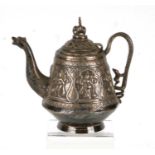 An Asian white metal teapot decorated in relief with figures and having a dragon spout and