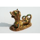 A Turkish Canakkale pottery figure in the form of a stylised recumbent lion, 18cms wide.Condition